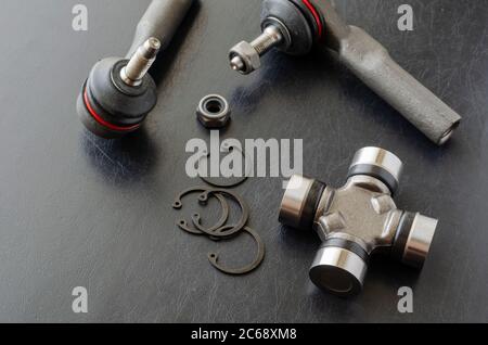 Cross joint of the propeller shaft and a set of tie rod ends. New auto parts for transmission. Trade Auto parts, car service. Automotive industry. Sel Stock Photo