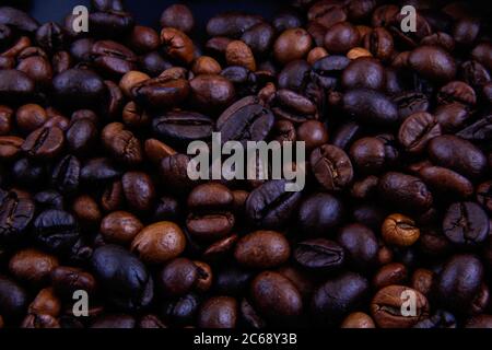 Coffee beans and coffee powder in the container and outside together. Stock Photo