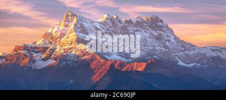 Sinrise or sunset panoramic banner view of the Dents du Midi in the Swiss Alps, canton Vaud, Switzerland Stock Photo
