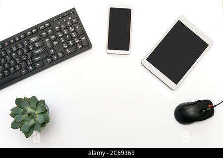 Cyber Monday flat lay on white background. Keyboard, tablet, phone, mouse and succulent composition. Copy space. Stock Photo