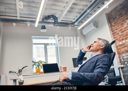 Portrait of middle aged entrepreneur having a conversation Stock Photo