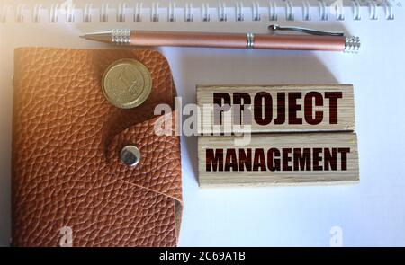 Project management words on wooden blocks, wallet, coins. Business concept Stock Photo