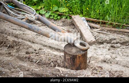 An old rusty trailer and a stump. A trailer for the transport of goods Stock Photo