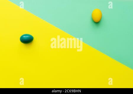 Turquoise and yellow eggs over mint and yellow background. Easter hipster concept. Unusual design, minimal concept. Stock Photo
