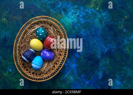 Multi-colored easter paint eggs in pottle on multi-colored background. Festive easter concept. Copy space. Stock Photo