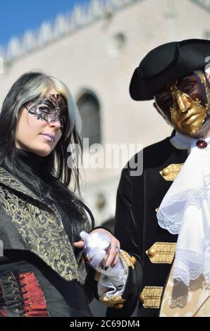 VENICE - MARCH 7: Two unidentified masked persons in costume in St. Mark's Square during the Carnival of Venice on March 7, 2011. The 2011 carnival wa Stock Photo