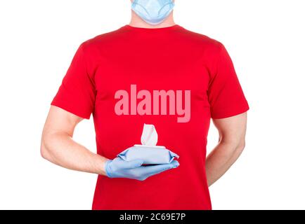Man in red t-shirt, medical mask and gloves holding wet wipes or tissue isolated Stock Photo