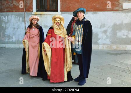 VENICE - MARCH 7: A family in costume on the Venice street during the Carnival of Venice on March 7, 2011. The 2011 carnival was held from February 26 Stock Photo