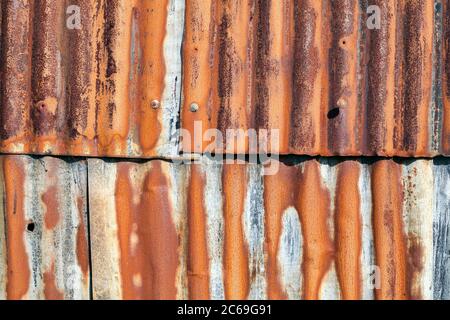 Distressed old corrugated rust covered iron fence texture background Stock Photo