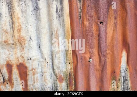 Distressed old corrugated rust covered iron fence texture background Stock Photo