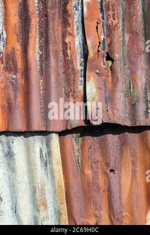 Distressed old corrugated rust covered iron fence texture background Stock Photo