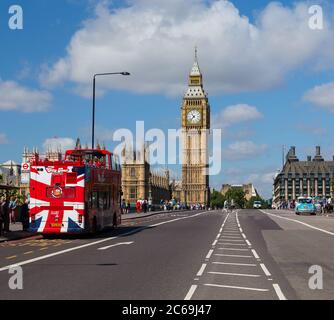 LONDON, UK - 21ST JULY 2015: The Elizabeth Tower and Westminster Bridge during the day. A bus and large amounts of people can be seen. Stock Photo