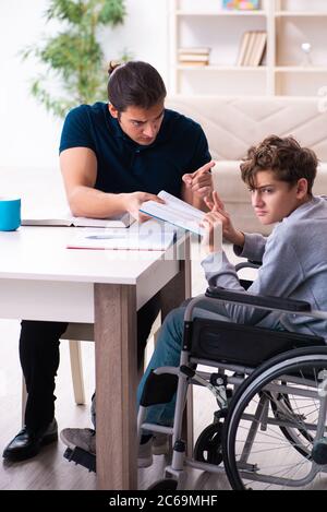 Father and disabled son in the education concept Stock Photo
