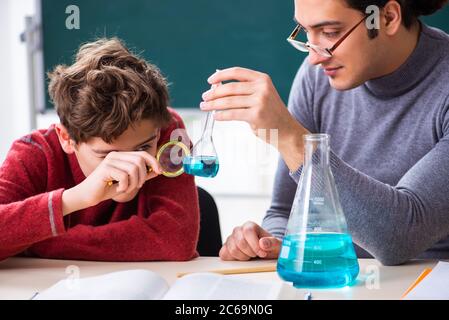 Young teacher and schoolboy in the classroom Stock Photo