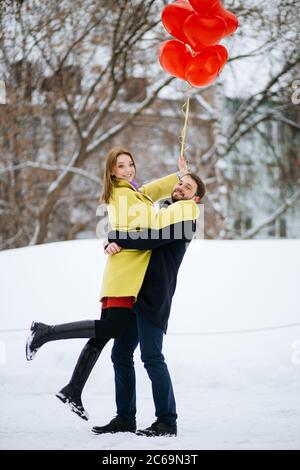 cheerful, joyfu, happy caucasian couple spend time together, man and woman in love, celebrate st valentines day in winter street, after romantic date Stock Photo