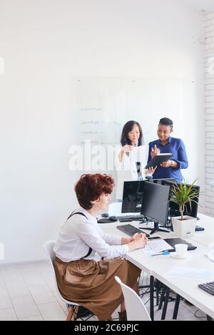 young business team working with new startup project laptop, computer . Project managers meeting. Analyze plans, papers, charts, diagram Stock Photo