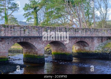 Light pink and green tones on the bridge over the River Dun (Glendun River) at Cushendun in County Antrim Northern Ireland Stock Photo