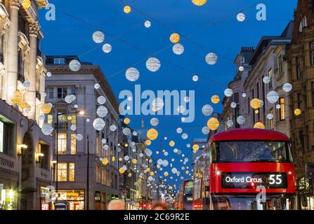 LONDON, UK - 23RD DECEMBER 2015: A view of Oxford Street during the Christmas Season showing buildings, decorations, people and traffic. Stock Photo