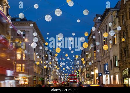 LONDON, UK - 23RD DECEMBER 2015: A view of Oxford Street during the Christmas Season showing buildings, decorations, people and traffic. Stock Photo