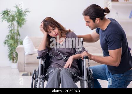 Disabled wife and husband at home Stock Photo