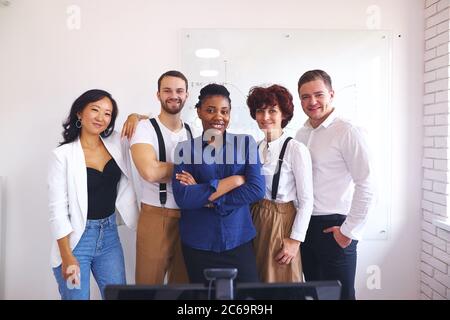 African leader posing in office together with multi-ethnic happy team, employees happy to work with such leader. portrait Stock Photo