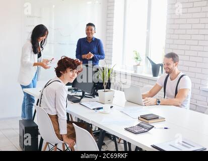 Business meeting of creative international partners, togetherness. Friendly business people in office discussing business ideas Stock Photo