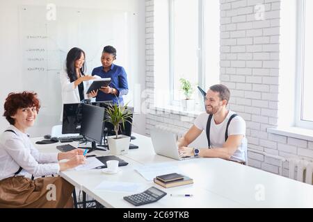 young business team working with new startup project laptop, computer . Project managers meeting. Analyze plans, papers, charts, diagram Stock Photo