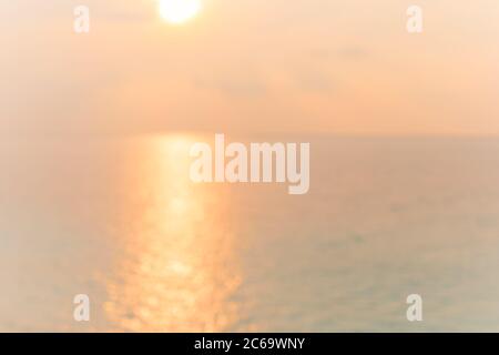 Blur sunset beach with bokeh sun light wave abstract background. Travel concept. Retro color style. Stock Photo