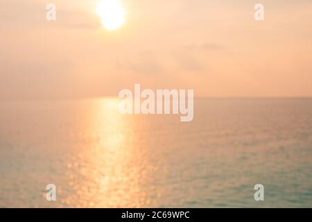 Blur sunset beach with bokeh sun light wave abstract background. Travel concept. Retro color style. Stock Photo