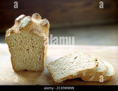 A spelt flour loaf of bread cut open and sliced. Stock Photo