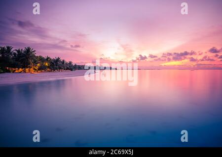 Sunset on the beach, tropical nature pattern. Amazing seascape with exotic island view. Coastline under colorful sky, dream sunset landscape, seascape Stock Photo