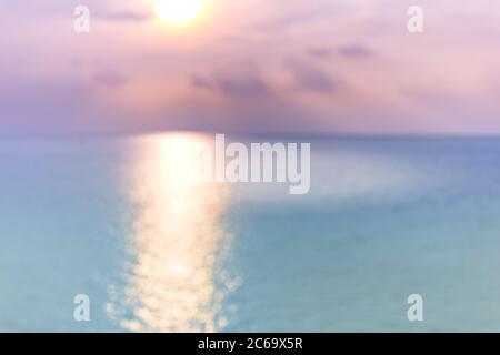Blur sunset beach with bokeh sun light wave abstract background. Travel concept. Retro color style. Stock Photo