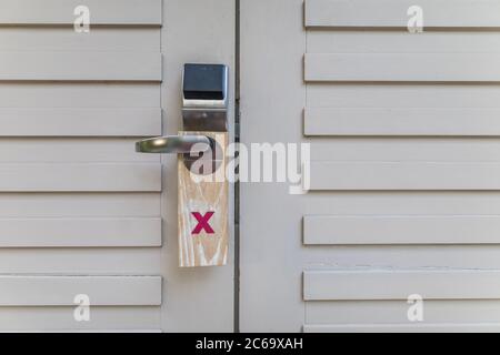 Do not disturb sign on hotel resort door. Wooden sign for privacy Stock Photo