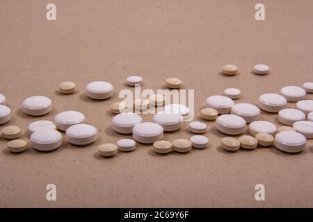 Colored tablets out of the package. Colored pills with a simple background and different colors together. Stock Photo