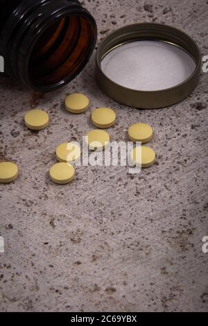 Colored tablets out of the package. Colored pills with a simple background and different colors together. Stock Photo