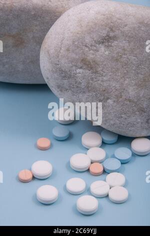 Colored tablets out of the package. Colored pills with a simple background and different colors together. Stock Photo