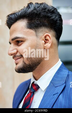 Smiling arabic guy. bristles on face of brunette, modern hair. Street background Stock Photo