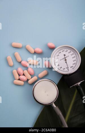 Top view of pills and capsules outside the package next to equipment and medical devices. Stock Photo