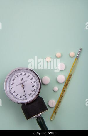 Top view of pills and capsules outside the package next to equipment and medical devices. Stock Photo