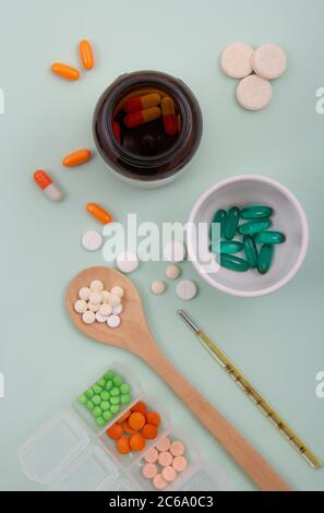 Top view of pills and capsules outside the package next to equipment and medical devices. Stock Photo