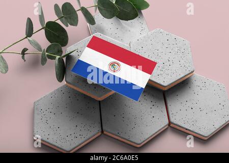 Paraguay flag on hexagon stylish stones. Pink copy space background. Flat lay, top view minimal national concept. Stock Photo