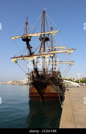 Replica of the Victoria ship a carrack and the first ship to circumnavigate the globe moored in Santander with strong morning sunlight Stock Photo