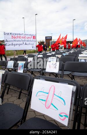 Hamburg, Germany. 08th July, 2020. Employees of the aircraft manufacturer Airbus are gathering outside the factory gates in Hamburg-Finkenwerder for a nationwide day of action against job cuts by the aircraft manufacturer. With the 2000 chairs in front of the main entrance, IG Metall wants to signal how many jobs are to be cut at the site. Credit: Christian Charisius/dpa/Alamy Live News Stock Photo