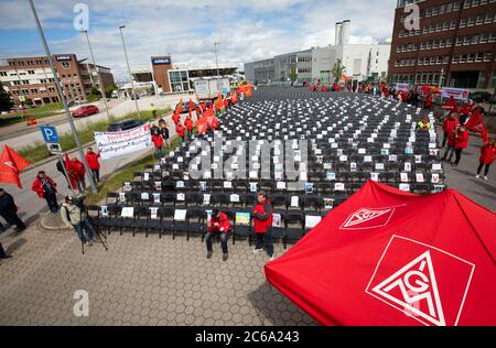 Hamburg, Germany. 08th July, 2020. Employees of the aircraft manufacturer Airbus are gathering outside the factory gates in Hamburg-Finkenwerder for a nationwide day of action against job cuts by the aircraft manufacturer. With the 2000 chairs in front of the main entrance, IG Metall wants to signal how many jobs are to be cut at the site. Credit: Christian Charisius/dpa/Alamy Live News Stock Photo