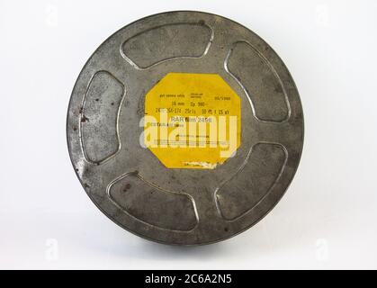 An original old film can with an orange label. For 16 mm film