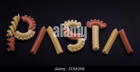 Shaped and colorful pasta in different sizes and colors together from close range. Stock Photo