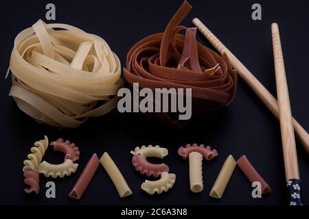 Shaped and colorful pasta in different sizes and colors together from close range. Stock Photo