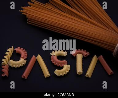 Shaped and colorful pasta in different sizes and colors together from close range. Stock Photo