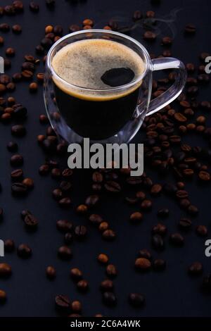 Different types of coffee and enough varieties in the black background in the top view that is poured on the wooden board. Stock Photo