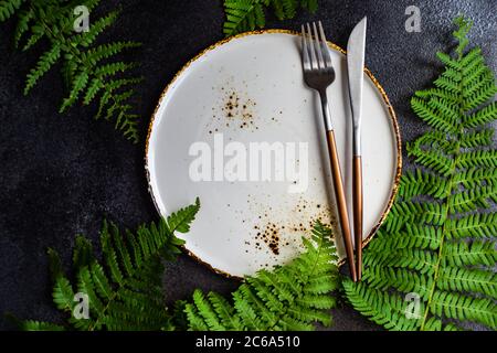 Rustic table and place setting with fern leaves Stock Photo